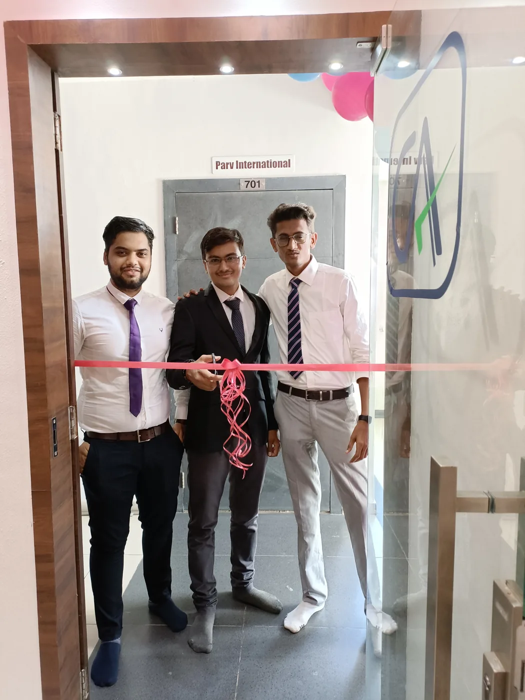 Ribbon being cut at the glass entrance of the CSM & Co LLP office